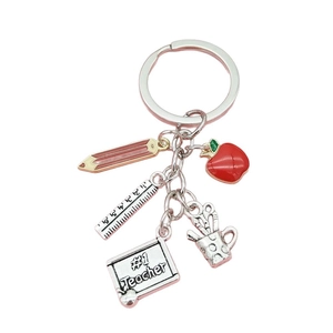Creative teacher keychain with red apple, pencil, ruler, and #1 Teacher charms in silver alloy