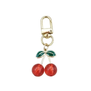 Cute acrylic cherry keychain with red fruit pendants and green leaves on gold ring