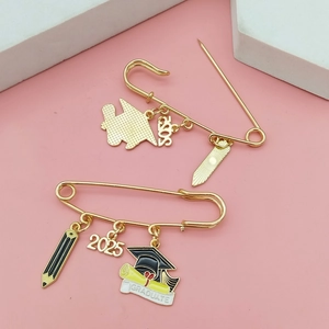 2025 graduation brooch with gold safety pin, pencil, cap and graduate scroll charms