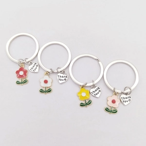 Set of four metal keychains with colorful enamel flowers and heart Thank You charms