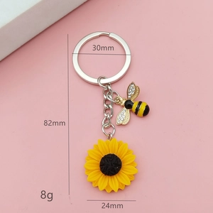 Porte-clés tournesol avec fleur en résine jaune et breloque abeille en cristal sur chaînette