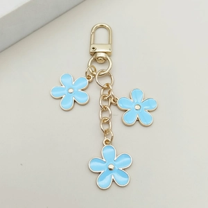 Detail of light blue alloy flower charms with gold lobster clasp for keychains