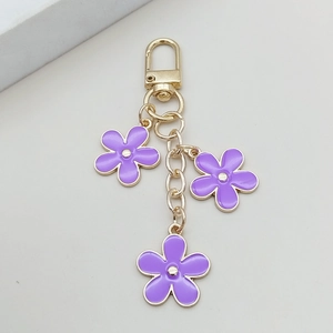 Sweet purple flower keychain with golden horseshoe clasp and three floral charms