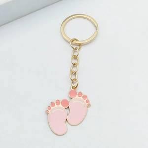 Golden baby footprint keychain with pink enamel drip, cute baby shower gift for bags