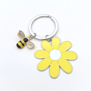 Detail of bee and sunflower keychain with sparkling rhinestones and yellow enamel finish