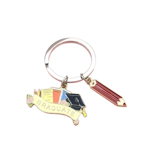 Enamel graduation keychain featuring academic cap, books, and red pencil pendant
