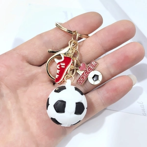 Close-up of a soccer keychain with 3D ball, football shoe, and golden heart soccer tag