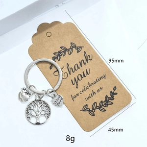 Porte-clés arbre et pomme argenté avec breloque de cœur et carte cadeau sur fond blanc