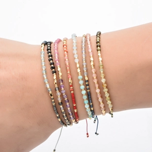 Close-up of colorful Miyuki beaded bracelets with adjustable woven ropes and semi-precious gems