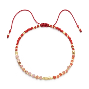 Detail of adjustable red hand-woven Miyuki bead bracelet with warm semi-precious stones