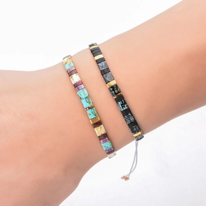Set of two handmade MIYUKI Tila bead bracelets with blue, black and gold square accents