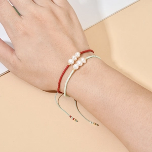 Detail of bohemian handmade beaded bracelets with freshwater pearls and adjustable cords