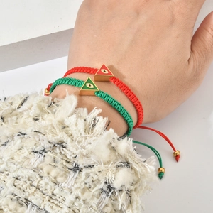 Handmade woven evil eye bracelets with gold enamel triangles in red and green colors