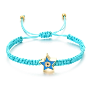 Detail of turquoise woven bracelet with a gold star pendant and blue evil eye enamel charm