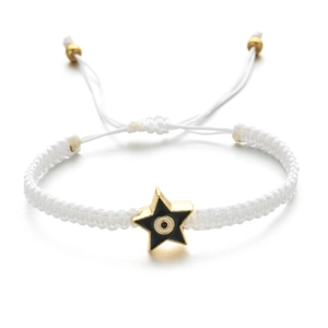 Detail of white woven bracelet with a star-shaped gold charm and evil eye enamel design