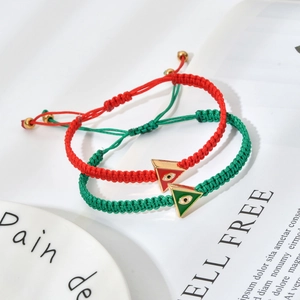 Adjustable woven evil eye bracelet set in red and green with triangular enamel charms