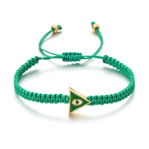 Detail of green braided rope bracelet with golden triangle evil eye charm and beads