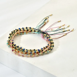 Detail of bohemian handmade beaded bracelets with colorful stones and adjustable cords