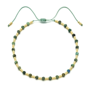 Detail of turquoise beaded necklace with gold metal spacers and adjustable slider knot