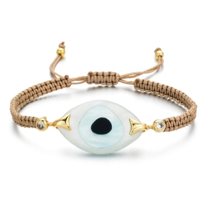 Detail of adjustable evil eye woven bracelet with gold beads and crystals