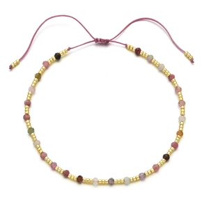 Detailed view of handmade colorful gemstone beaded bracelet with adjustable pink cord