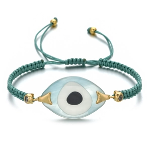 Macro view of adjustable teal woven cord bracelet featuring a blue evil eye bead detail