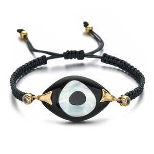 Detail of adjustable evil eye bracelet with black cord and sparkling zircon accents