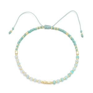 Minimalist MIYUKI bead bracelet in mint blue and gold with adjustable woven cord strap