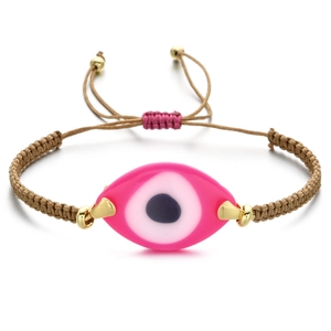 Detailed view of woven Greek evil eye bracelet with pink pendant and adjustable gold beads