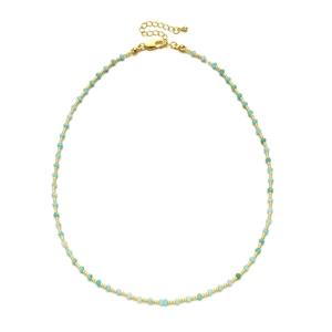 Detail of handmade beaded necklace with sky blue beads and golden metal spacers