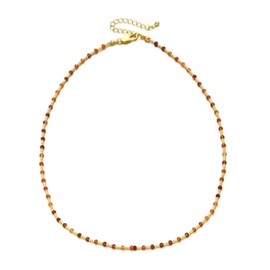 Detail of 2mm orange faceted stone beads and gold cylinder spacer beads on a necklace