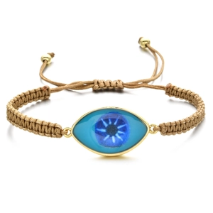 Macro detail of the evil eye braided bracelet with adjustable cord and golden beads