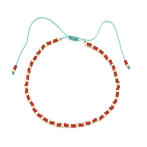 Bohemian handmade beaded bracelet with red beads and adjustable light blue cord strap