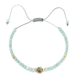 Detail of bohemian light green faceted stone beads bracelet with adjustable grey cord