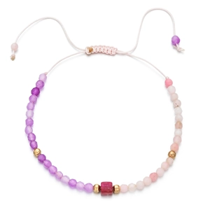 Detail of bohemian beaded bracelet with purple stones and adjustable pink woven cord