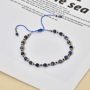 Detail of bohemian adjustable bracelet with blue faceted stones and gold bead accents