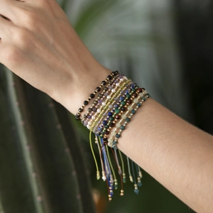 Close-up of bohemian multi-layer handmade faceted stone beaded bracelets on female wrist