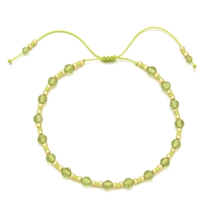 Detail of bohemian adjustable bracelet with olive green faceted stone beads and gold accents