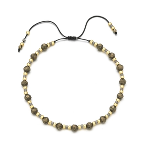 Detail of bohemian beaded bracelet featuring faceted stone beads and adjustable cord