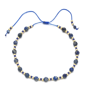 Detail of bohemian woven bracelet with 4mm faceted blue stone beads and adjustable cord