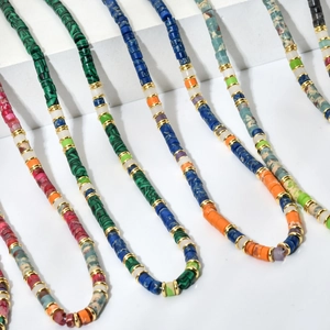 Handmade bohemian beaded necklace with colorful natural stone discs and gold spacers