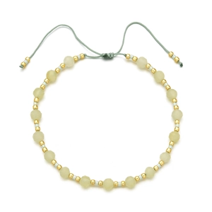Detail of bohemian woven bracelet with 4mm green faceted stones and golden beads