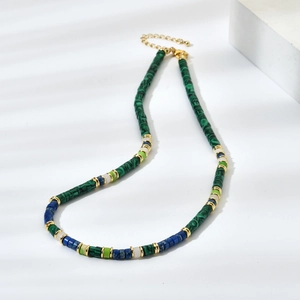 Detailed macro view of colorful natural stone beads with gold spacers on ethnic necklace