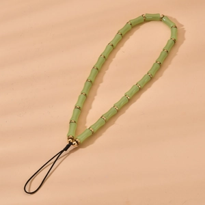 Detailed view of bamboo-shaped green crystal beads with golden rings for phone straps