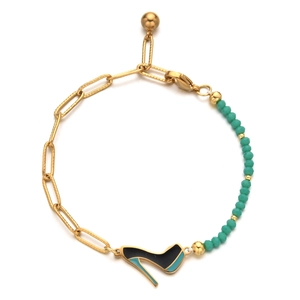 Detail of asymmetric bracelet with gold links, turquoise beads and high heel charm