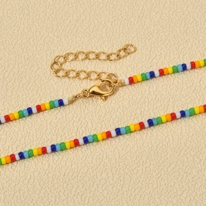 Detail of colorful rainbow beads necklace with adjustable gold-tone lobster clasp