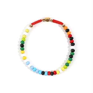 Close-up of vibrant enamel bead necklace with golden clasp and red woven cord detailing