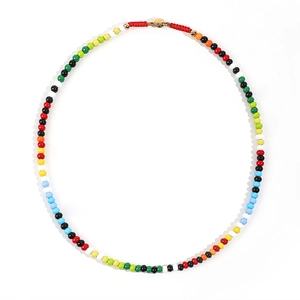 Close-up of colorful beaded necklace with gold clasp and red woven rope detail