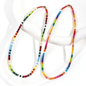 Colorful enamel beaded necklace with vibrant hues and gold clasp for a trendy summer look