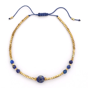 Detail van bohemien handgemaakte kralenarmband met blauwe stenen en gouden kralen